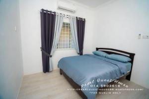 a bedroom with a bed with blue pillows and a window at Pearl Guest House in Kertih