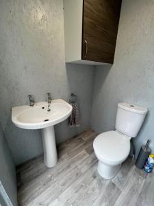 a bathroom with a toilet and a sink at Superior Luxury Large Emperor Tent in Stoke Goldington