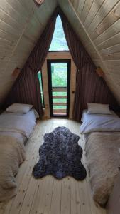 - une chambre avec 2 lits et un tapis au sol dans l'établissement mood villa Kazbegi, à Kazbegi