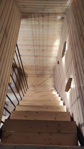 a staircase in a room with a wooden wall and a ceiling at mood villa Kazbegi in Stepantsminda