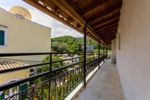 a balcony of a house with a view at Kampos Kassiopi Apartment in Kassiopi