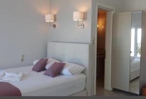 a bedroom with a white bed with two pillows at Seaview dreams in Ormos Panagias