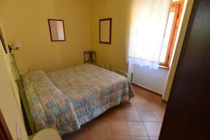A bed or beds in a room at Appartamento Le More