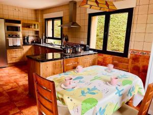 una cocina con mesa y mantel. en Villa Arboleda, en La Losa