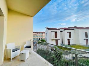 a balcony with two chairs and a view of buildings at A casa di Valentina, bilocale ai chiassarelli in Massa Marittima