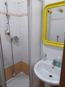 a bathroom with a shower and a sink and a mirror at Casa al mare in Santa Maria del Focallo