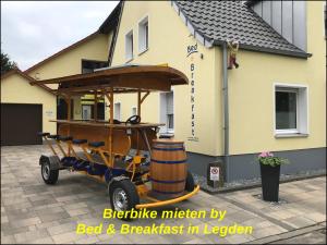 a beer cart parked in front of a house at Bed & Breakfast Pension in Legden