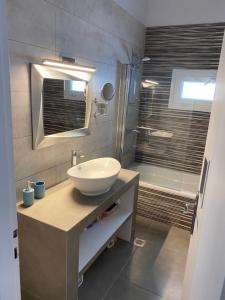 a bathroom with a sink and a shower at Tranquil sea view villa in Argostoli +18 photos