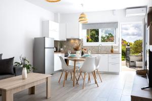a kitchen with a table and chairs and a refrigerator at Casa il Megliore in Argostoli