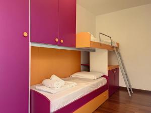 a small bedroom with a bunk bed with a ladder at Villa Eden a Levico Terme in Levico Terme