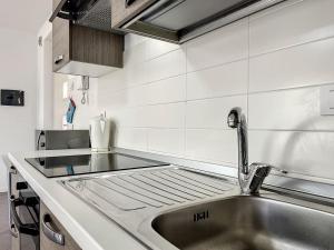 a kitchen with a sink and a counter top at Villa Eden a Levico Terme in Levico Terme +17 photos