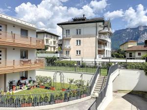 a building with a fence in front of a yard at Villa Eden a Levico Terme in Levico Terme