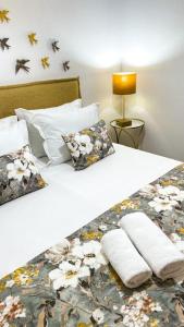 a large bed with two pillows on it with at Sitio Terra do Loureiro in Porto de Mós