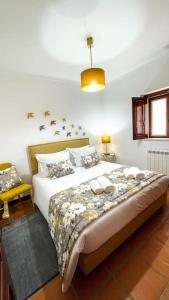 a bedroom with a bed with birds on the wall at Sitio Terra do Loureiro in Porto de Mós