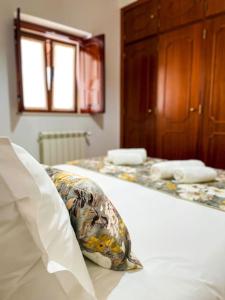 a pillow sitting on a bed in a bedroom at Sitio Terra do Loureiro in Porto de Mós