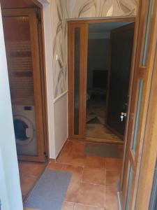 a bathroom with a toilet and a glass door at Casa Marco in Galaţi