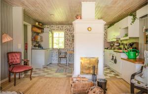 a kitchen with a fireplace in the middle of a room at 2 Bedroom Amazing Home In Vindeln in Vindeln