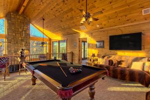 a living room with a pool table in a cabin at Soaring Eagle in Sautee Nacoochee