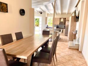 a dining room with a wooden table and chairs at Nerria's Villa in Kalamaki Chanion