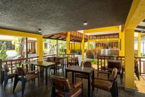 a restaurant with tables and chairs on a patio at Tuong Boutique Mui Ne in Mui Ne