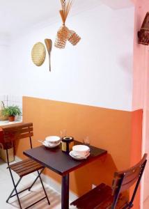 a small table with two bowls on it with two chairs at Tiny yet Beautiful apartment in the heart of Phnom Penh, Near central market in Phnom Penh