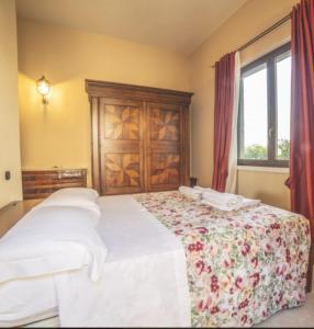 a bedroom with two beds and a window at LA CASA NELLA PRATERIA in Misano Adriatico