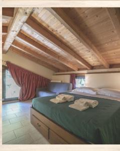 a bedroom with a bed with two towels on it at LA CASA NELLA PRATERIA in Misano Adriatico