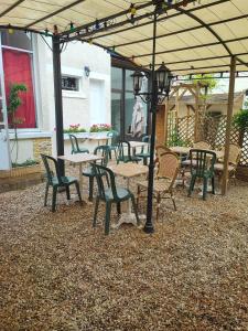 a group of tables and chairs under an umbrella at la madeleine in Saint-Benoît-sur-Loire
