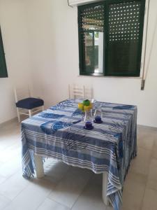 a blue and white table with a bowl of fruit on it at Villa Lucia in Santa Maria Del Focallo