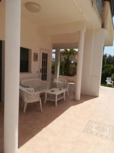 a patio with chairs and a table on a house at Villa Lucia in Santa Maria Del Focallo