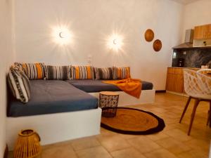 a living room with a couch and a kitchen at Vithos in Agnontas