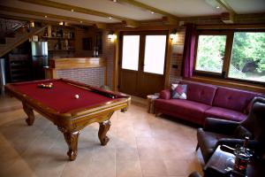 a living room with a pool table and a couch at Brezova Poljana Lodge in Vrbovsko