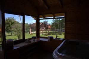 a bathroom with a sink and a large window at Brezova Poljana Lodge in Vrbovsko