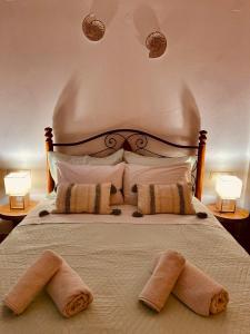 a bedroom with a bed with two towels on it at Vithos in Agnontas