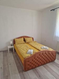 a large bed in a bedroom with a wooden floor at Apartman Sofija in Banja Luka