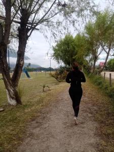 a woman is running down a dirt road at Suzet House in Oxapampa