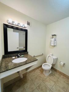 a bathroom with a sink and a toilet at Rodeway Inn in Silver Springs