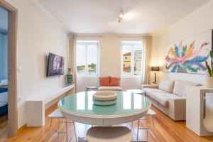a living room with a table and a couch at Paxos Fairytales House 1 in Gaios