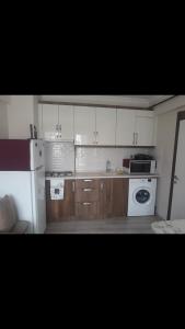 a kitchen with a white refrigerator and a stove at I can host in Bursa