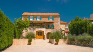 a large stone house with a yellow door at Villa Ca'Pietra, rustic stone house in Malinska