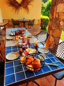 a table with a breakfast of croissants and orange juice at Villa Costera B&B in Sant Antoni de Calonge