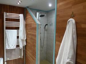 a bathroom with a shower with a glass door at La Suite du Pêcheur, balnéo et terrasse privative. Entre terre et mer in Tréméoc