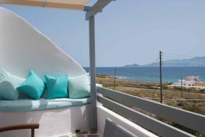 a balcony with a couch and a view of the ocean at Meltemi 1 in Nea Cryssi Akti