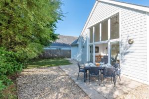 a patio with a table and chairs in front of a house at Seashells in Woolacombe