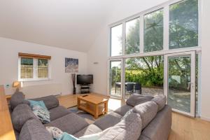 a living room with a couch and a tv at Seashells in Woolacombe