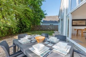 a table with plates and glasses on a patio at Seashells in Woolacombe