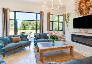 a living room with couches and a coffee table at The Mill in Briston