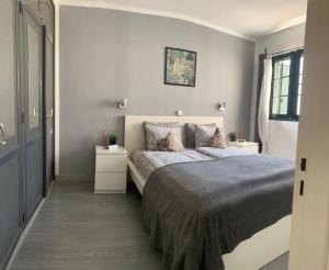 a bedroom with a bed and two night stands at Apartamentos Albatros in Puerto del Carmen