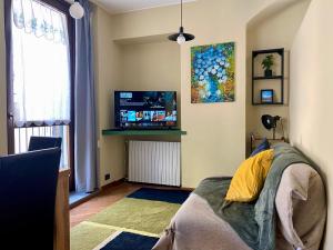 a bedroom with a bed and a flat screen tv at Urban Oasis in the Heart of Turin in Turin