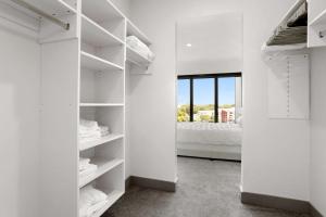 a white walk in closet with a bed at Luxury Apt in West Midtown in Atlanta